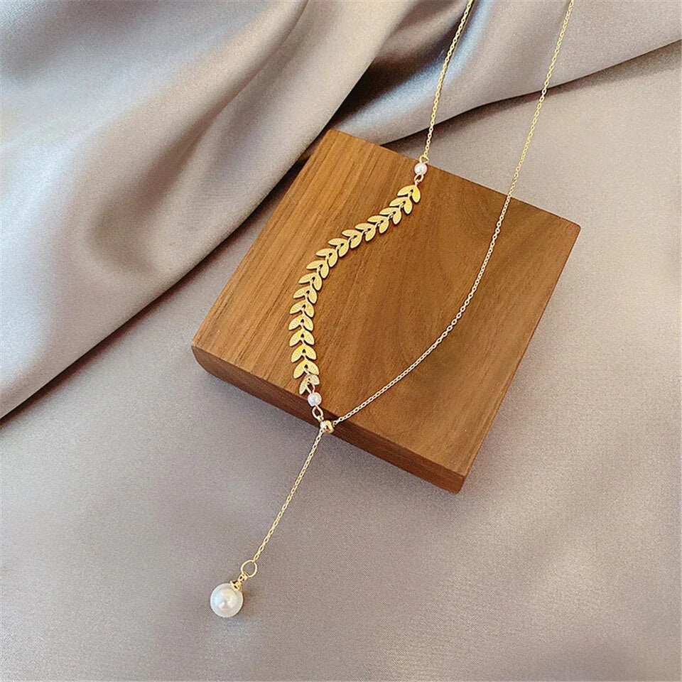 Conjunto bañado en oro de 18 quilates con perla